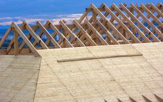 construction equipment dealers - House roof under construction.